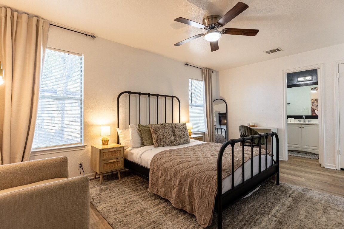 2012 Balsam Way Round Rock, TX 78665 - Photo 21 of 30 Bedroom with wood finished floors, ceiling fan, and ensuite bath