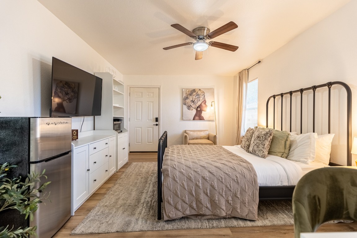 2012 Balsam Way Round Rock, TX 78665 - Photo 22 of 30 Bedroom featuring light wood-style floors, a ceiling fan, and freestanding refrigerator