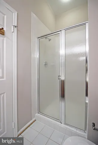 a bathroom with a glass shower door