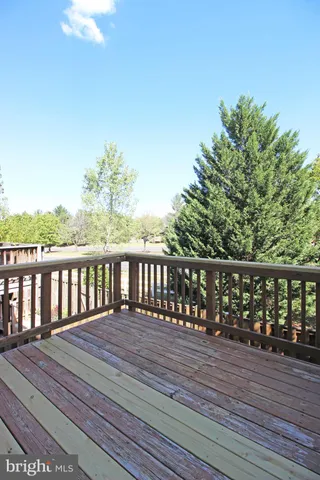 a balcony with wooden floor and fence