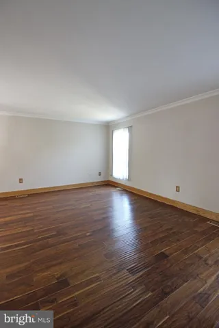 a view of room with wooden floor and window
