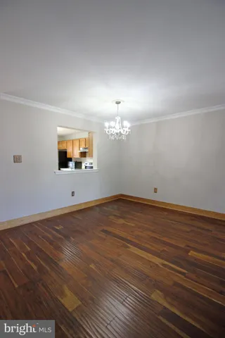 a view of a room with wooden floor and flat screen tv