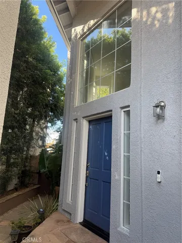 an empty room with wooden floor fireplace and windows