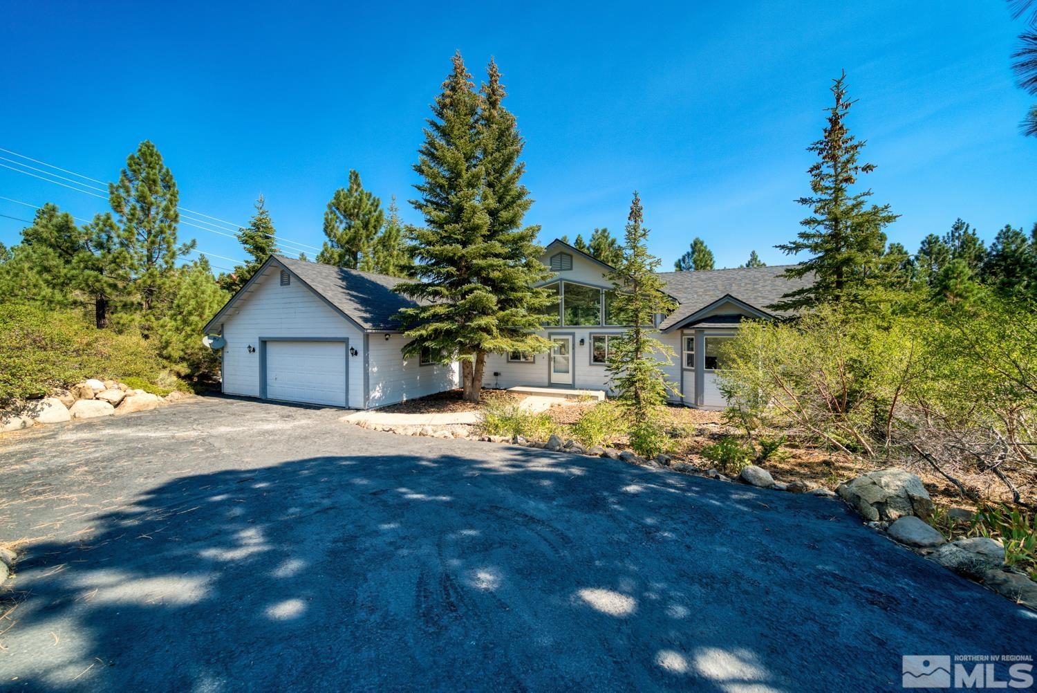 50 Sunridge Drive Reno, NV 89511 - Photo 1 of 30 a front view of a house with a yard and garage