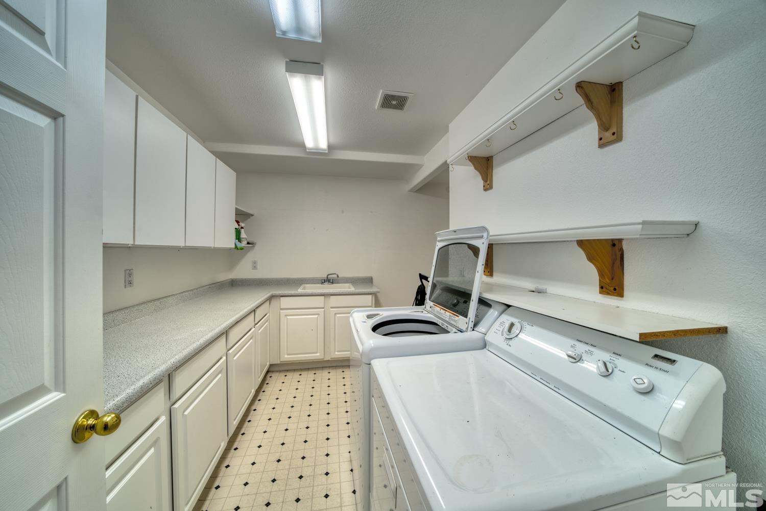 50 Sunridge Drive Reno, NV 89511 - Photo 13 of 30 a kitchen with sink a stove and cabinets