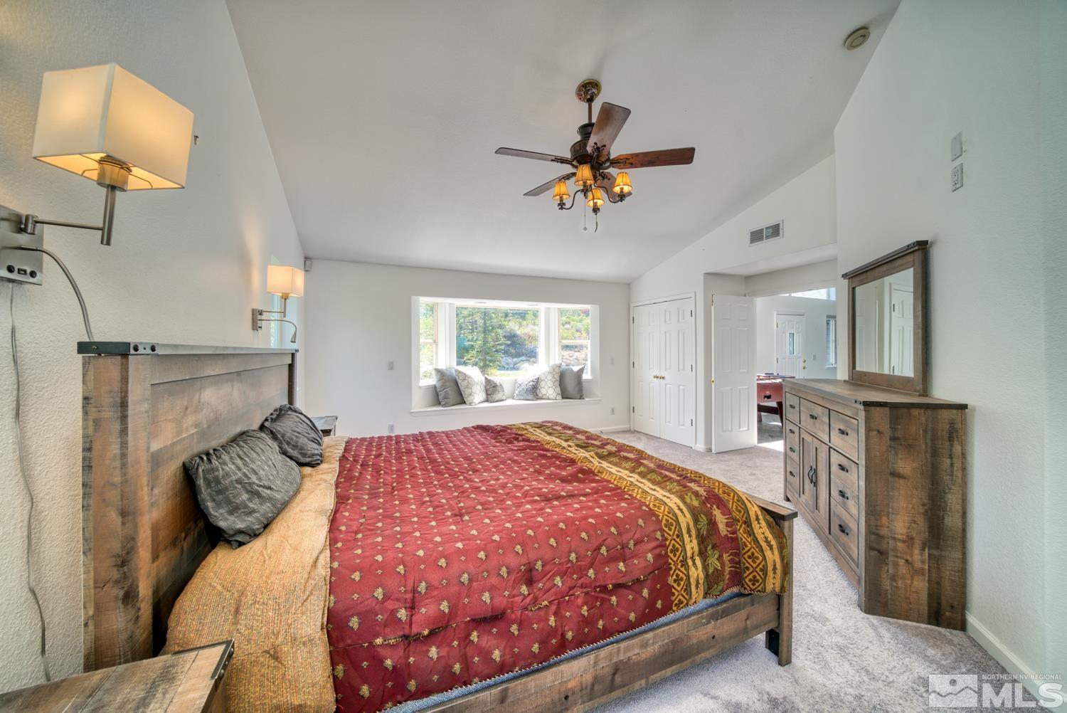 50 Sunridge Drive Reno, NV 89511 - Photo 14 of 30 a bedroom with a bed a dresser and potted plants with the wooden floor