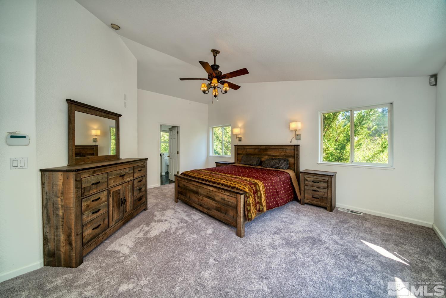50 Sunridge Drive Reno, NV 89511 - Photo 15 of 30 a bedroom with a bed and a chandelier