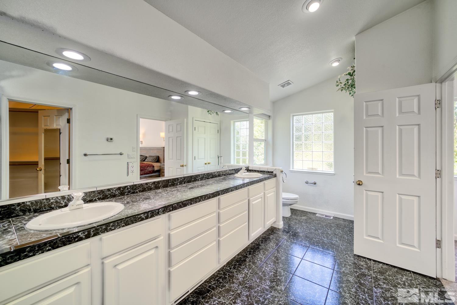 50 Sunridge Drive Reno, NV 89511 - Photo 17 of 30 a spacious bathroom with a granite countertop sink mirror and a toilet