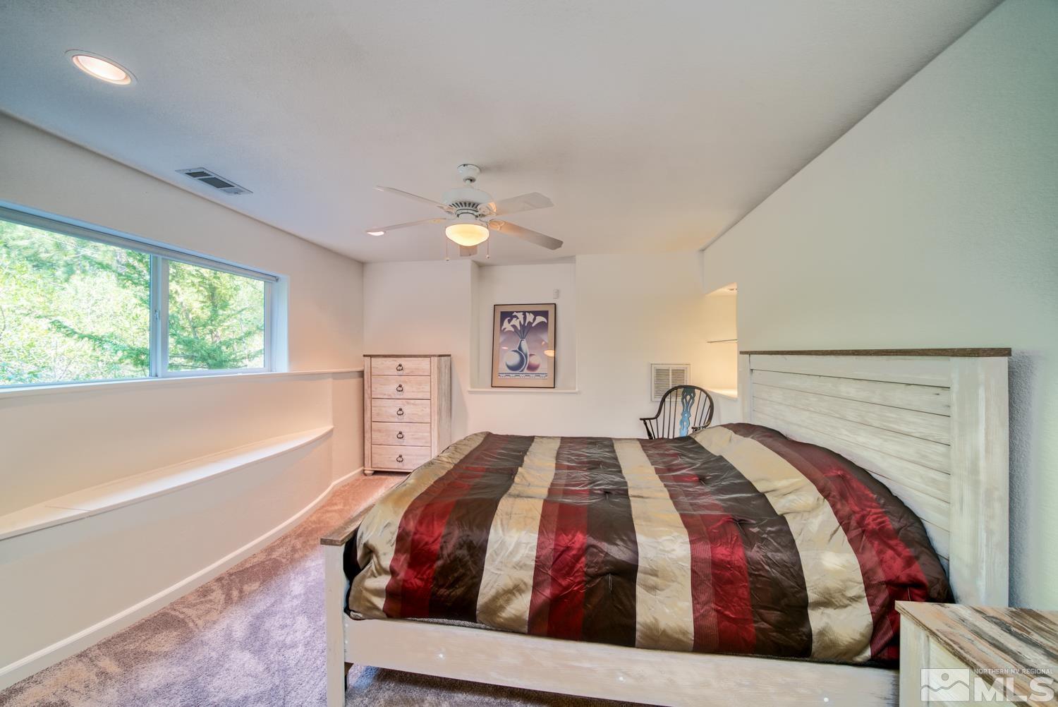50 Sunridge Drive Reno, NV 89511 - Photo 23 of 30 a bedroom with a large bed and a large window