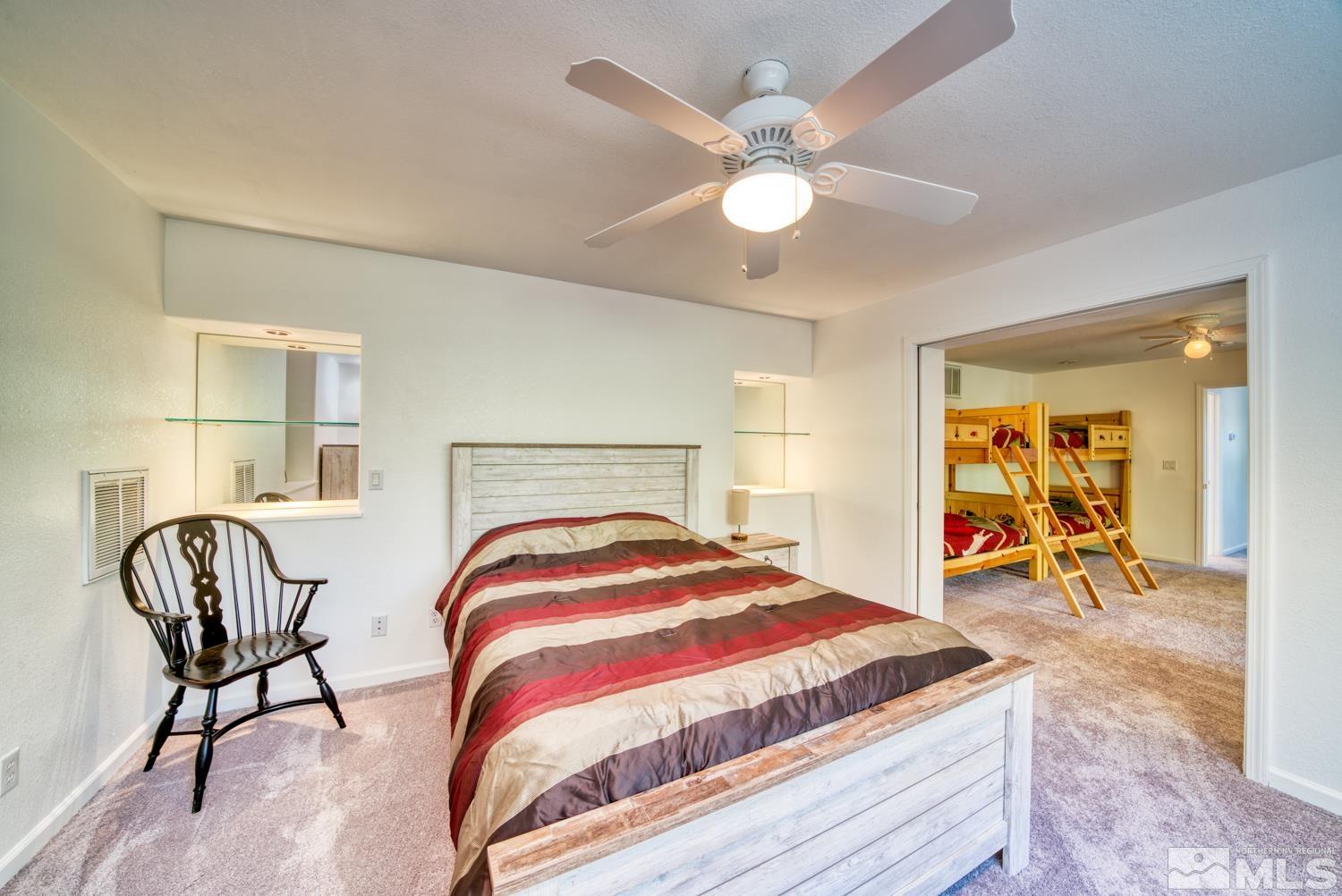 50 Sunridge Drive Reno, NV 89511 - Photo 24 of 30 a bedroom with a bed and chair