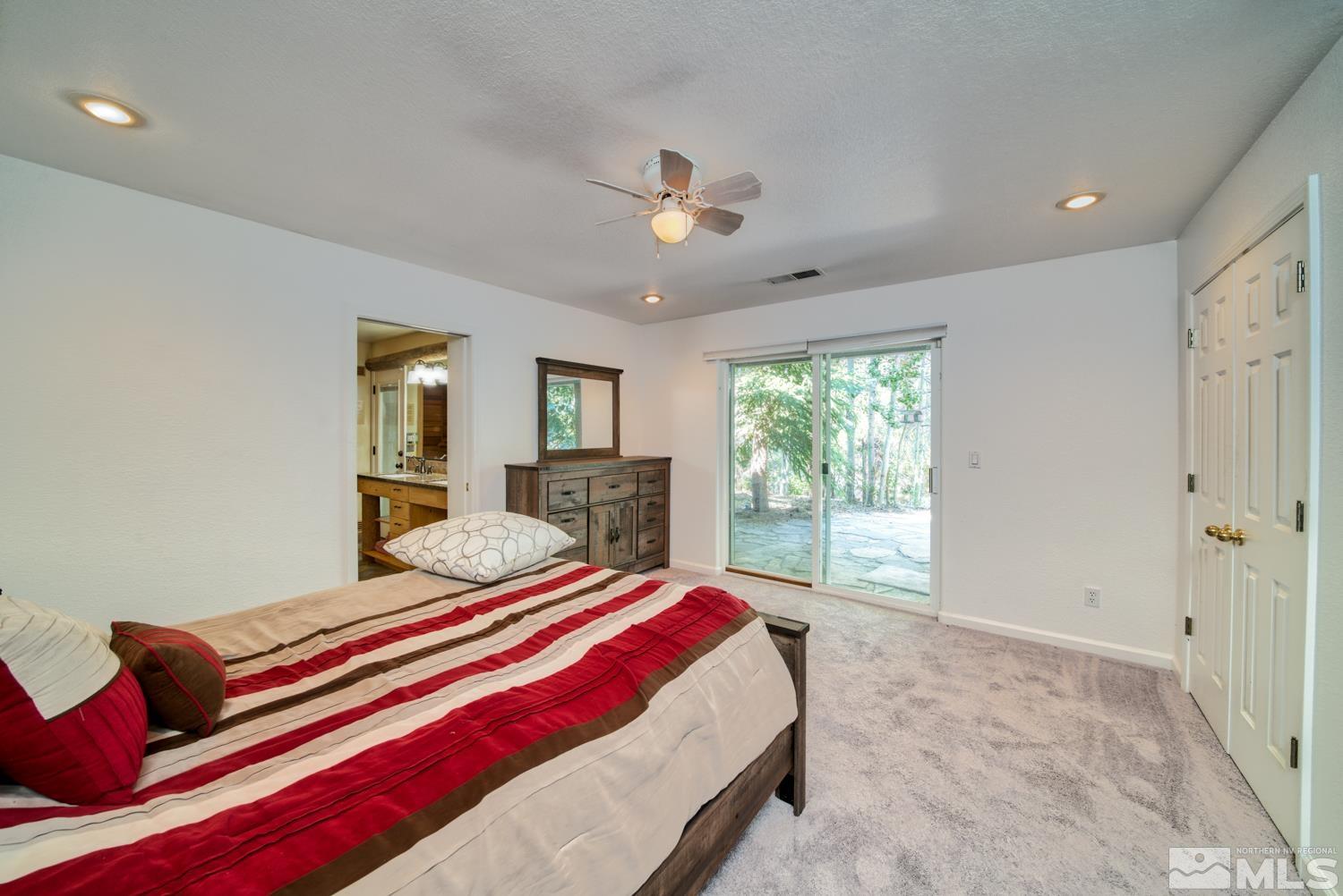 50 Sunridge Drive Reno, NV 89511 - Photo 25 of 30 a bedroom with a large bed and a chandelier