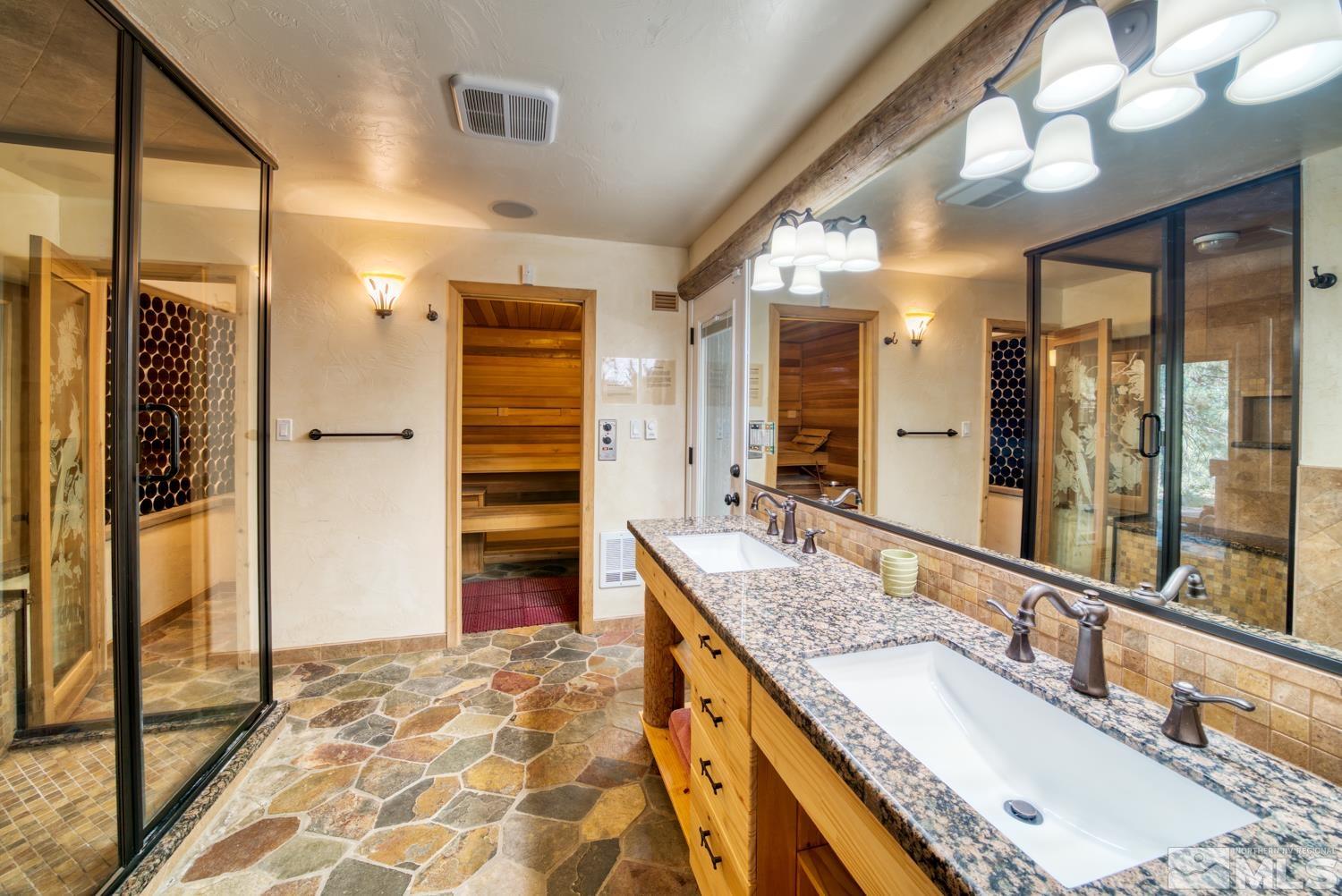 50 Sunridge Drive Reno, NV 89511 - Photo 26 of 30 a bathroom with a granite countertop sink and a mirror