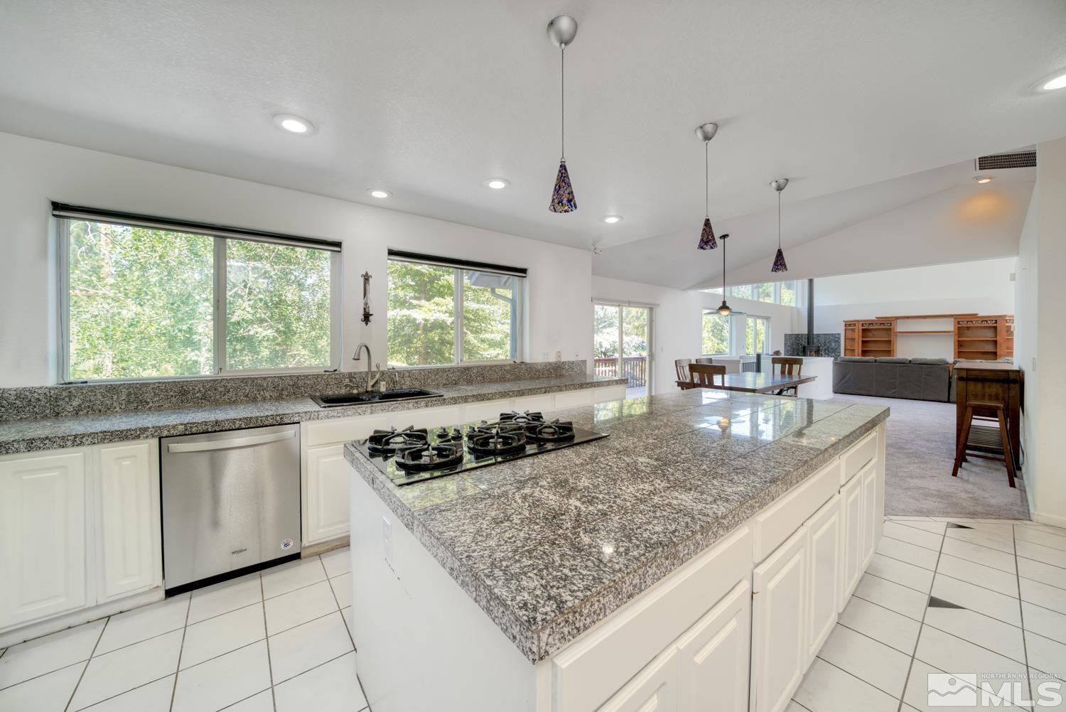 50 Sunridge Drive Reno, NV 89511 - Photo 8 of 30 a kitchen with stainless steel appliances granite countertop a sink and a white cabinets