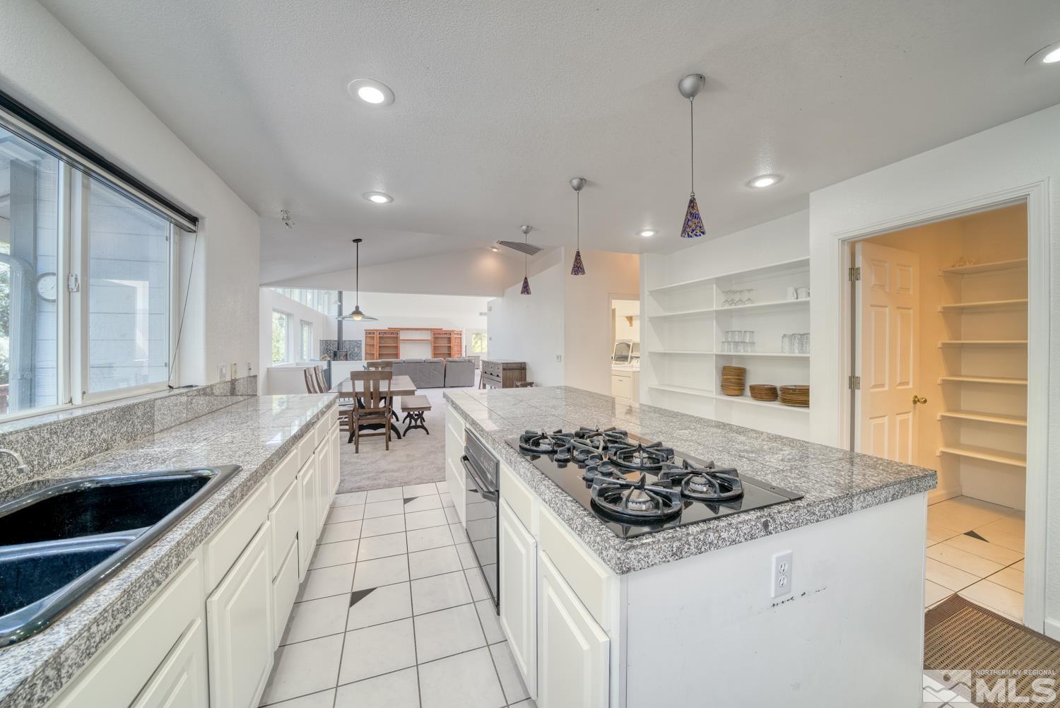 50 Sunridge Drive Reno, NV 89511 - Photo 9 of 30 a kitchen with stainless steel appliances granite countertop a sink stove and cabinets