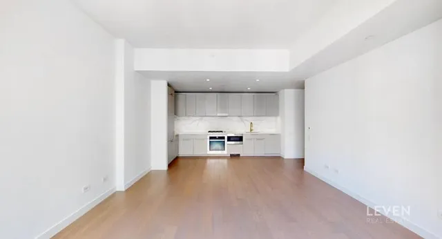 a view of a kitchen with a sink and a refrigerator
