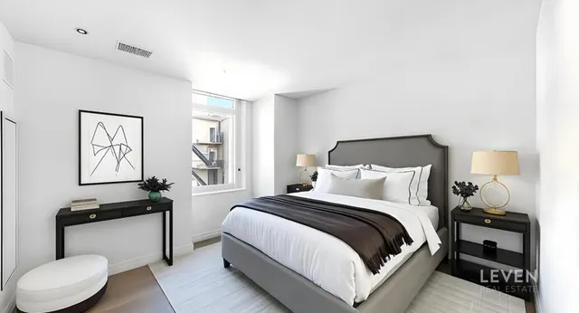 a bedroom with a bed and a lamp