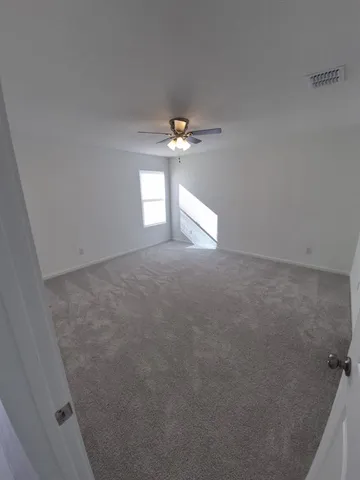 a view of an empty room with a window