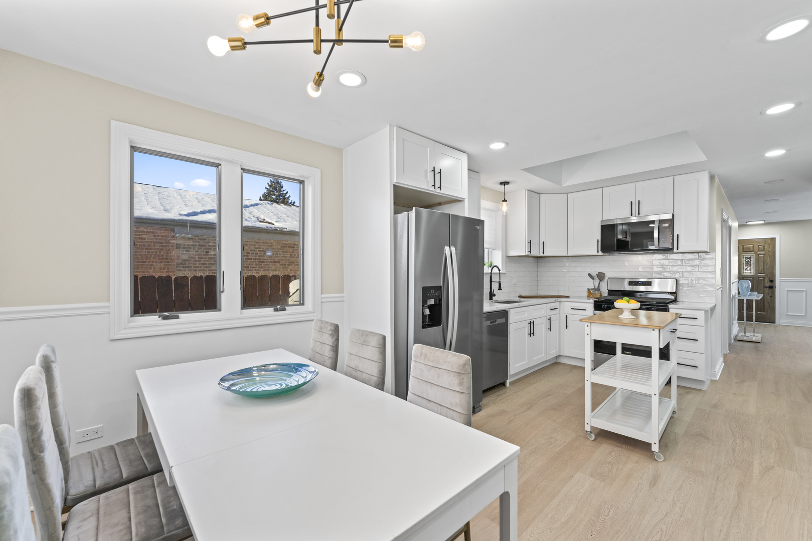 8169 South Tripp Avenue Chicago, IL 60652 - Photo 14 of 31 a kitchen with stainless steel appliances a refrigerator a stove a sink a dining table and chairs