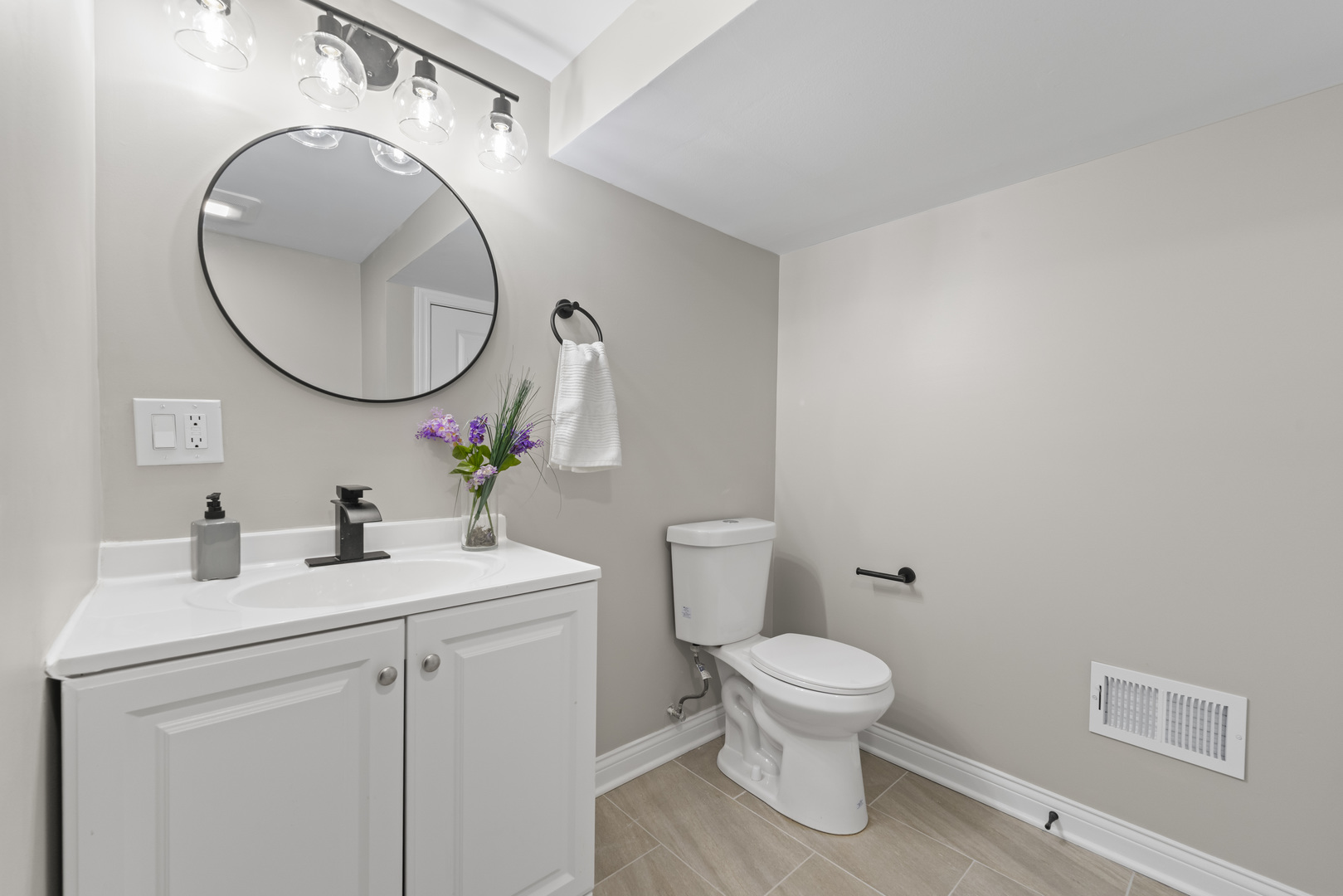 8169 South Tripp Avenue Chicago, IL 60652 - Photo 26 of 31 a bathroom with a toilet a sink and a mirror