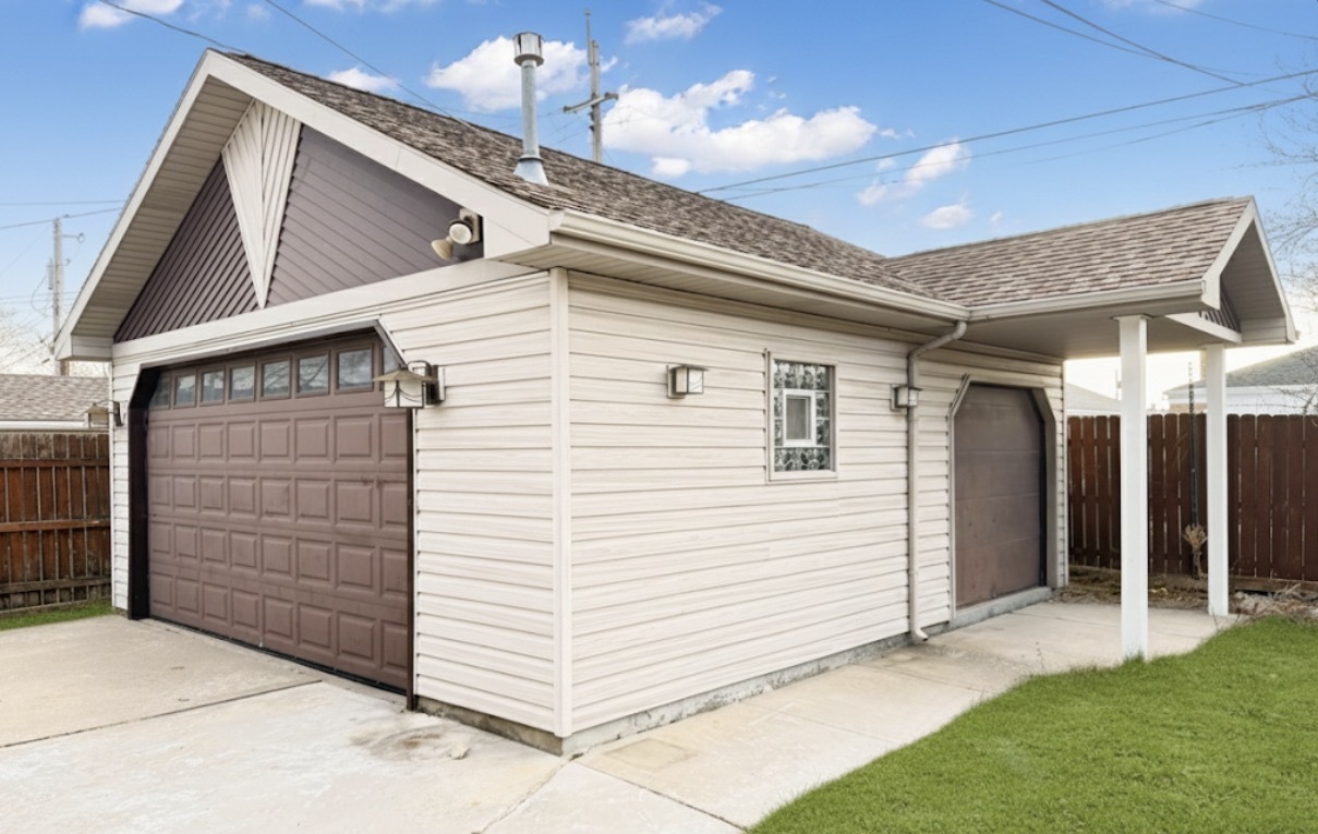 8169 South Tripp Avenue Chicago, IL 60652 - Photo 4 of 31 a view of a white house with a small yard and wooden fence