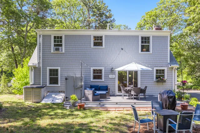 a view of a house with swimming pool and sitting area