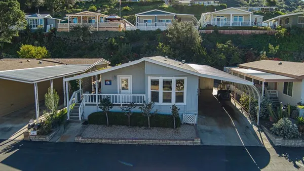 a view of house with outdoor space and sitting area