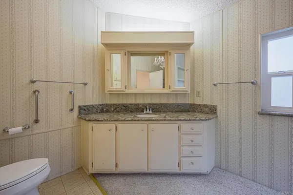 a view of a grassy field with mountains in the background