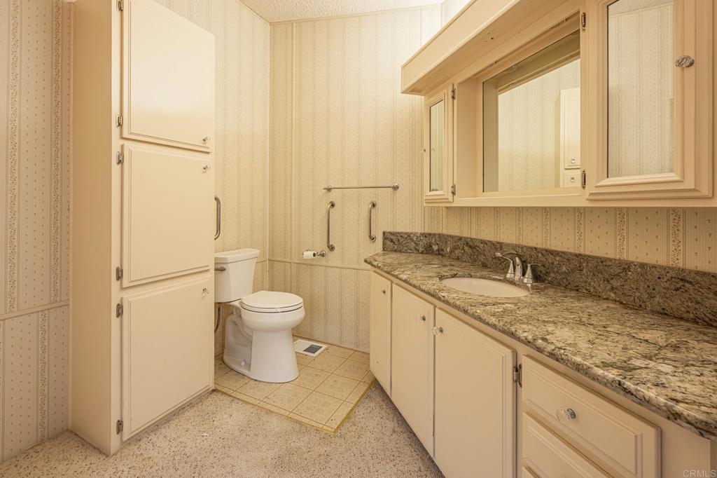 4650 Dulin Road, Unit 175 Fallbrook, CA 92003 - Photo 28 of 53 a bathroom with a granite countertop toilet and sink