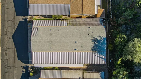 an aerial view of multiple houses with yard