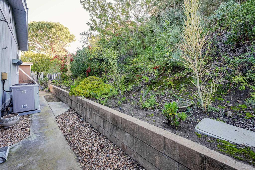 4650 Dulin Road, Unit 175 Fallbrook, CA 92003 - Photo 36 of 53 a view of a garden with wooden bench