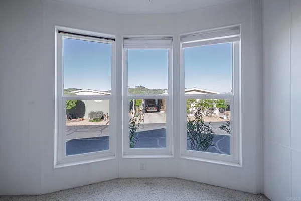 a large kitchen with white cabinets and stainless steel appliances