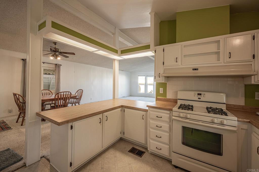4650 Dulin Road, Unit 175 Fallbrook, CA 92003 - Photo 9 of 53 a kitchen with white cabinets and appliances