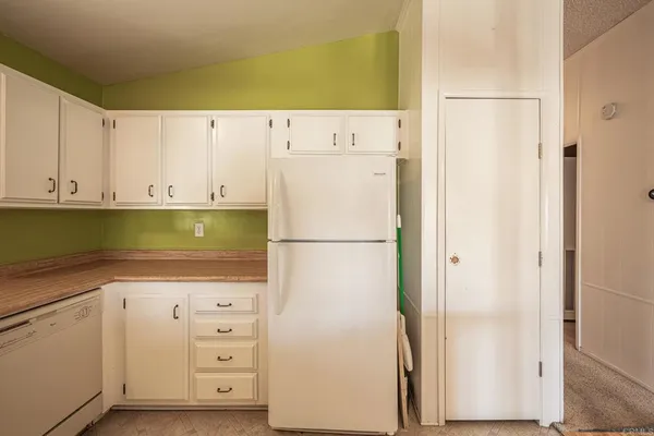 an empty room with fan and entrance