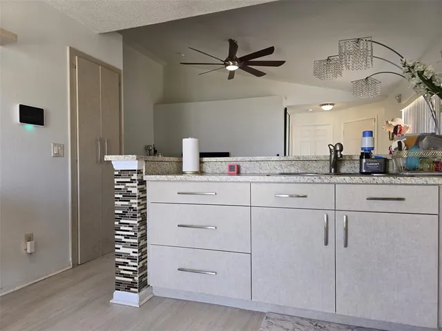 a kitchen with cabinets and white appliances