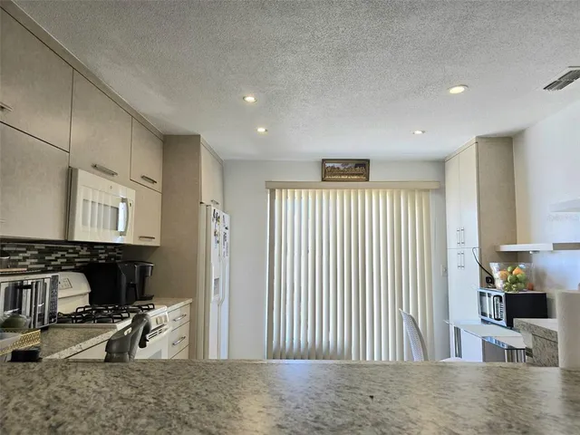 a view of a livingroom with furniture and staircase