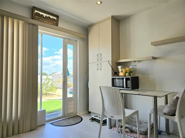 a view of a dining room with furniture and a window