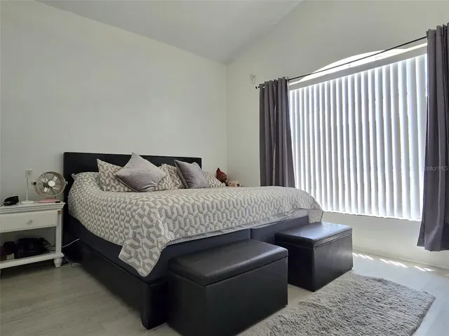 a bedroom with bed and window