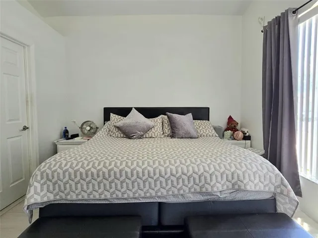 a bedroom with a bed and window