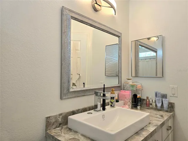 a bathroom with a sink and a mirror