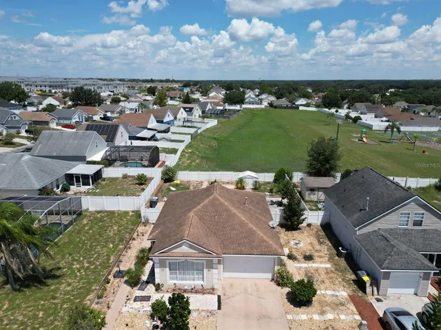 an aerial view of a house with a garden and lake view