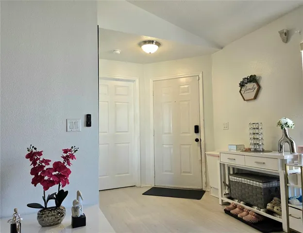 a hallway with a flower pot and a fireplace