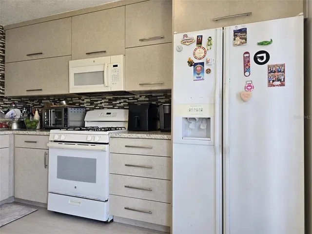 a white refrigerator freezer sitting inside of a kitchen