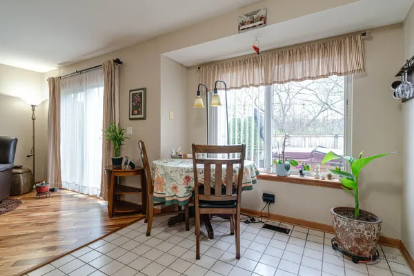 a living room with stainless steel appliances furniture and a kitchen view