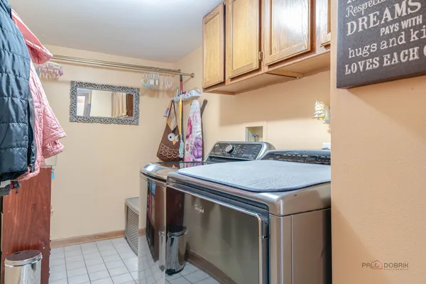 a bed sitting in a bedroom next to a window and dresser