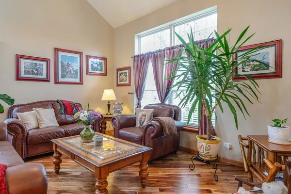 a living room with furniture lamp and window