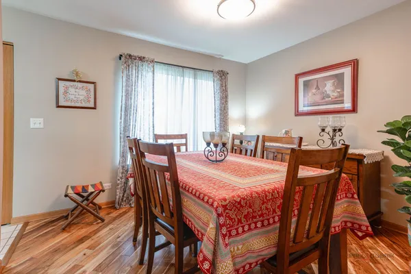 a view of a dining room with furniture and wooden floor