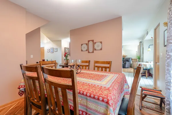 a view of a dining room with furniture and a floor to ceiling window
