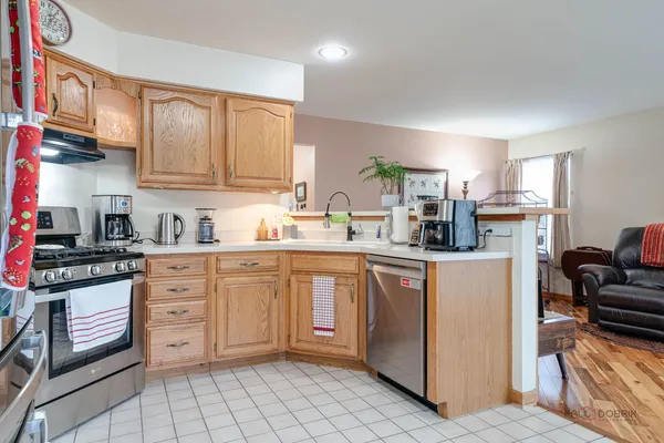 a kitchen with stainless steel appliances granite countertop a refrigerator sink and cabinets
