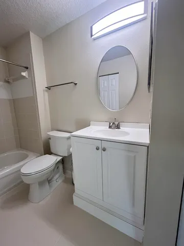 a bathroom with a toilet sink and a mirror