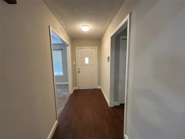 a view of hallway with wooden floor